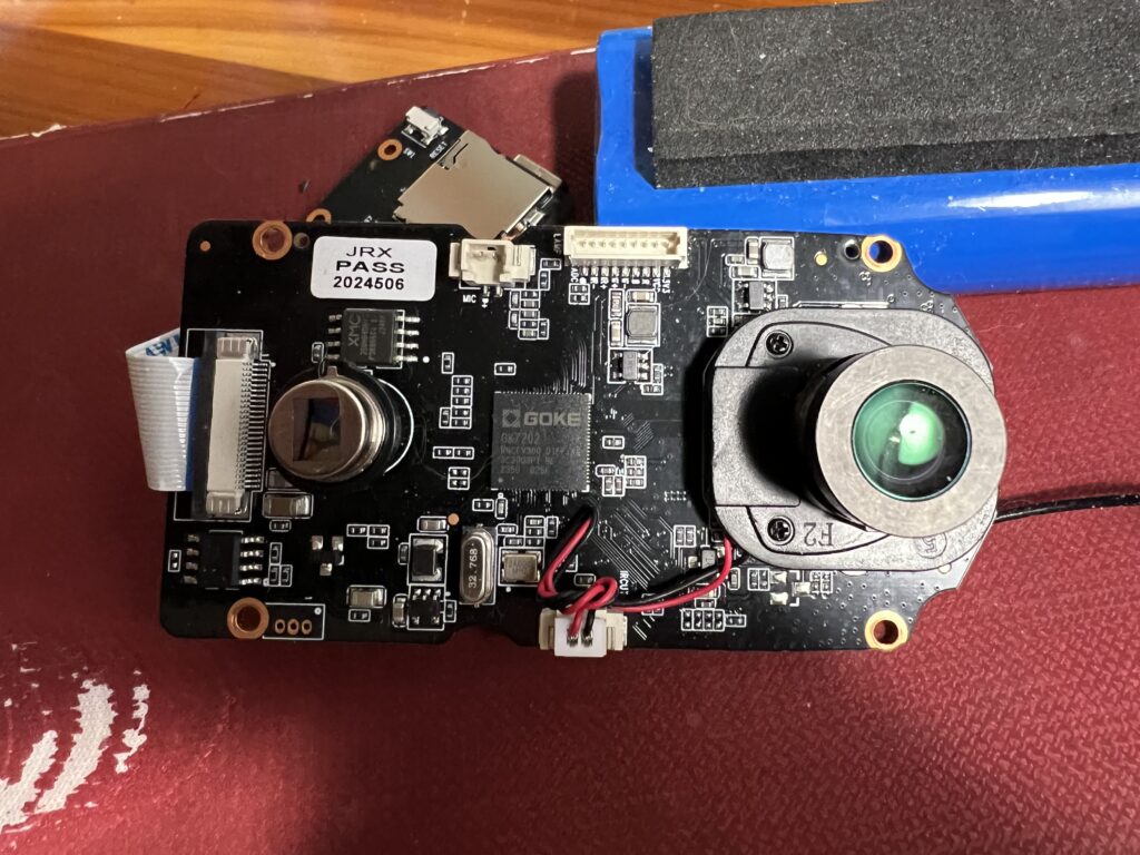 Front view of the main Hello Birdie circuit board, showing a PIR sensor, Goke GK7202v300 SoC, SPI NOR flash chip and camera lens housing